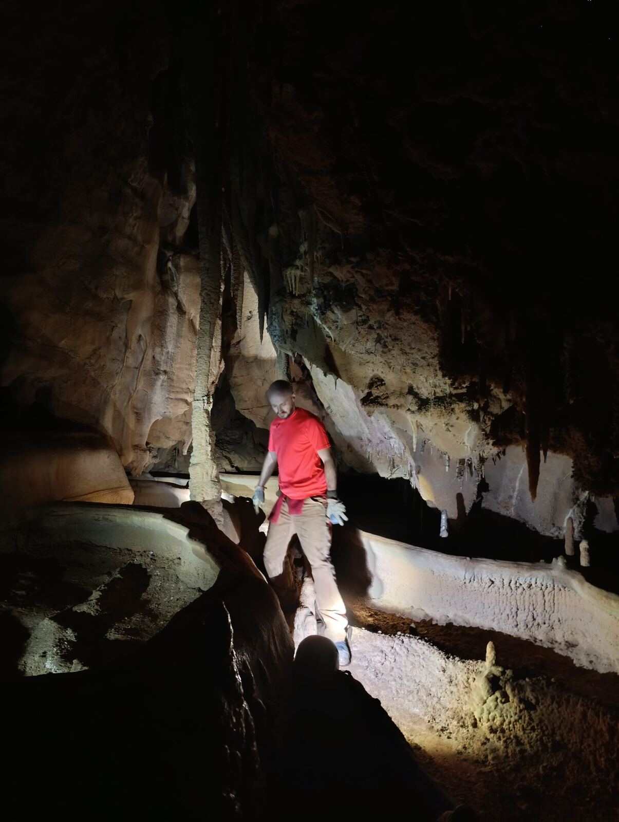 Caver among cave formations